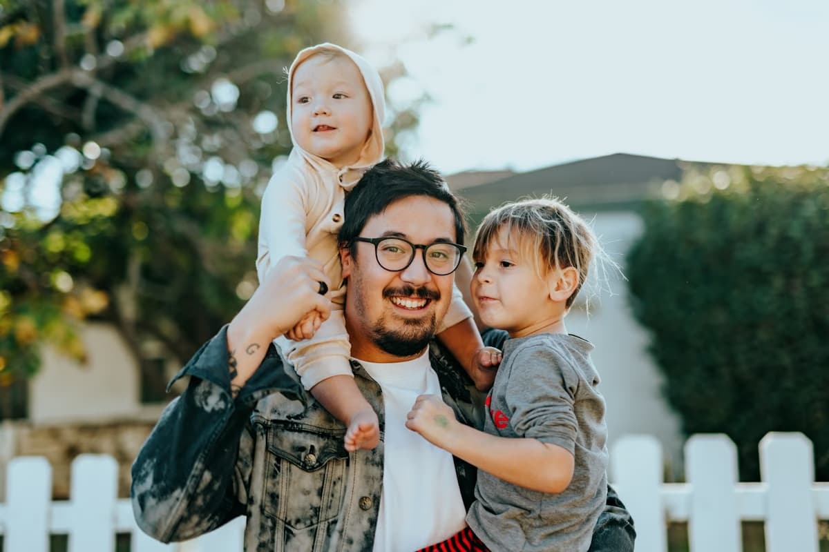 Mom, dad, and two kids laughing together in their Mabank backyard